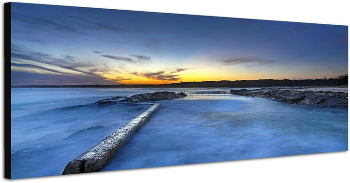 Paul Sinus Art Panoramabild auf Leinwand und Keilrahmen 150x50cm Steine Küste Meer Sonnenuntergang
