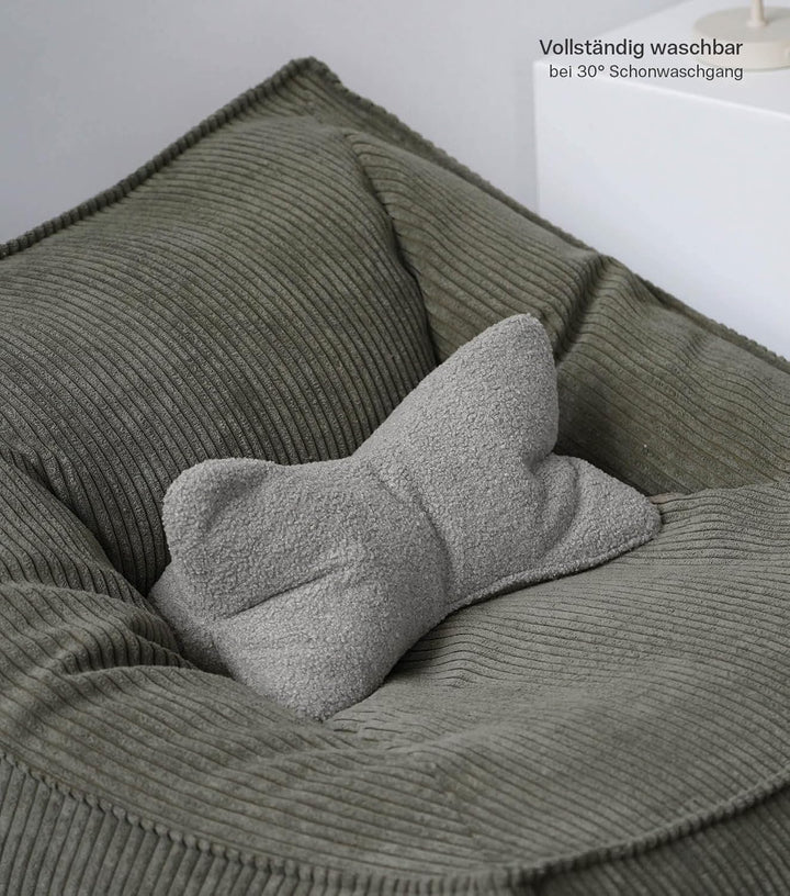 mokebo 'Der Leseknochen' Lesekissen aus weichen Bouclé-Stoff, ergonomisches Nackenkissen aus gemütli