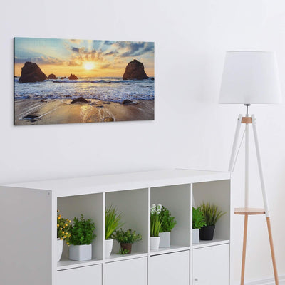 PICANOVA – Bild auf Leinwand Felsiger Strand Sonnenuntergang 100x50cm – Leinwandbild – Premium Leinw