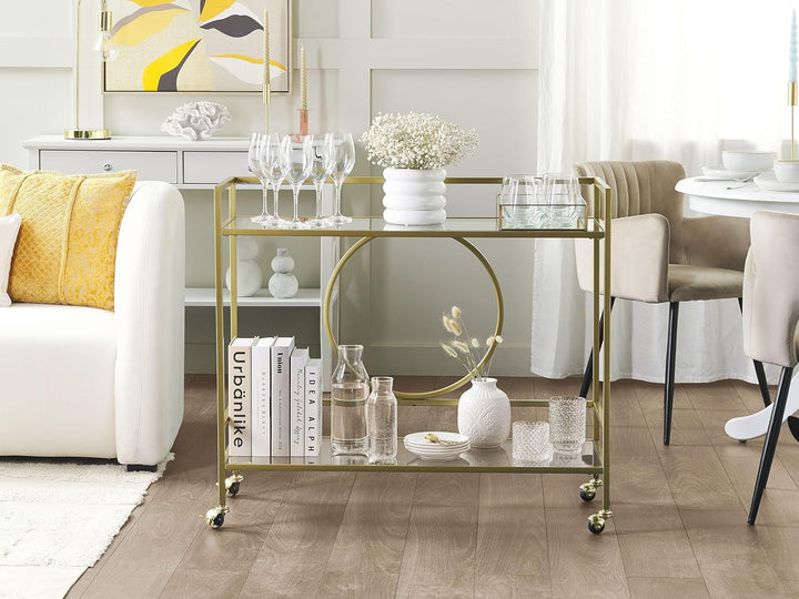 Beliani Servierwagen Glasplatte transparent/Gold mit Rollen glamourös Kerry
