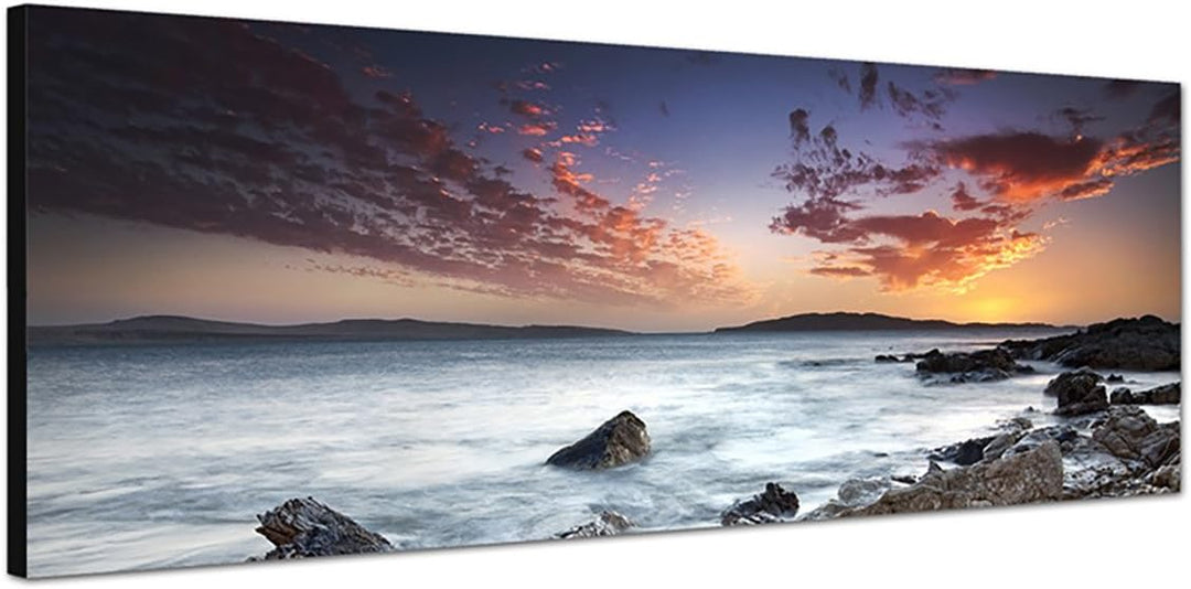 Paul Sinus Art Panoramabild auf Leinwand und Keilrahmen 150x50cm Meer Steine Felsen Abendhimmel