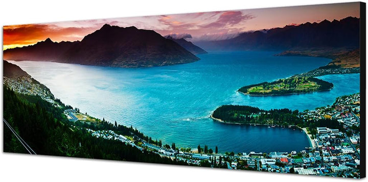 Paul Sinus Art Panoramabild auf Leinwand und Keilrahmen 150x50cm See Stadt Berge Landschaft Dämmerun