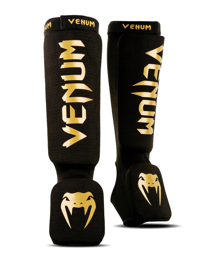Venum Art: Uni Kontact Schienbein-und Fussschutz M schwarz / gold