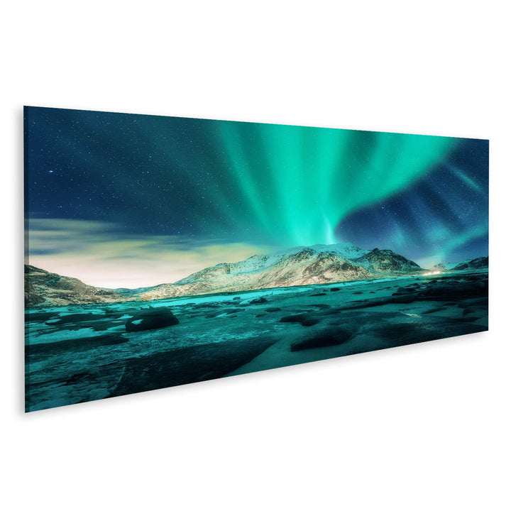 Bild auf Leinwand Aurora über verschneite Berge, Sandstrand mit Steinen. Nordlicht auf den Lofoten,