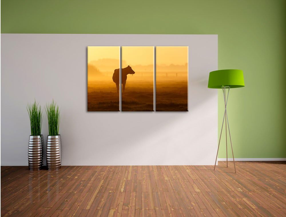 Pixxprint eine fressende Kuh auf der Weide als Leinwandbild - Grösse: 3-Teilig (120x80cm) - Wandbild
