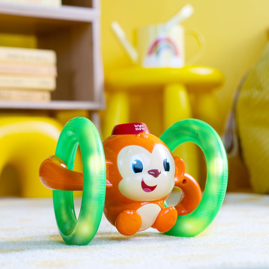 Bright Starts, Musikspielzeug AFFE mit leuchtenden, selbst Rollenden Rädern, Spielt Musik und Wirkt