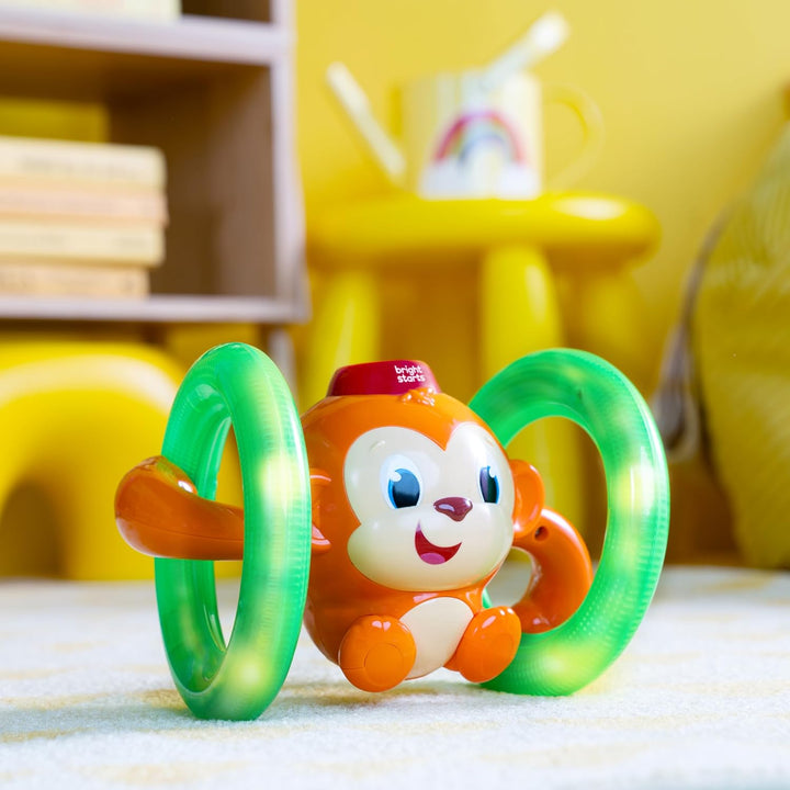 Bright Starts, Musikspielzeug AFFE mit leuchtenden, selbst Rollenden Rädern, Spielt Musik und Wirkt