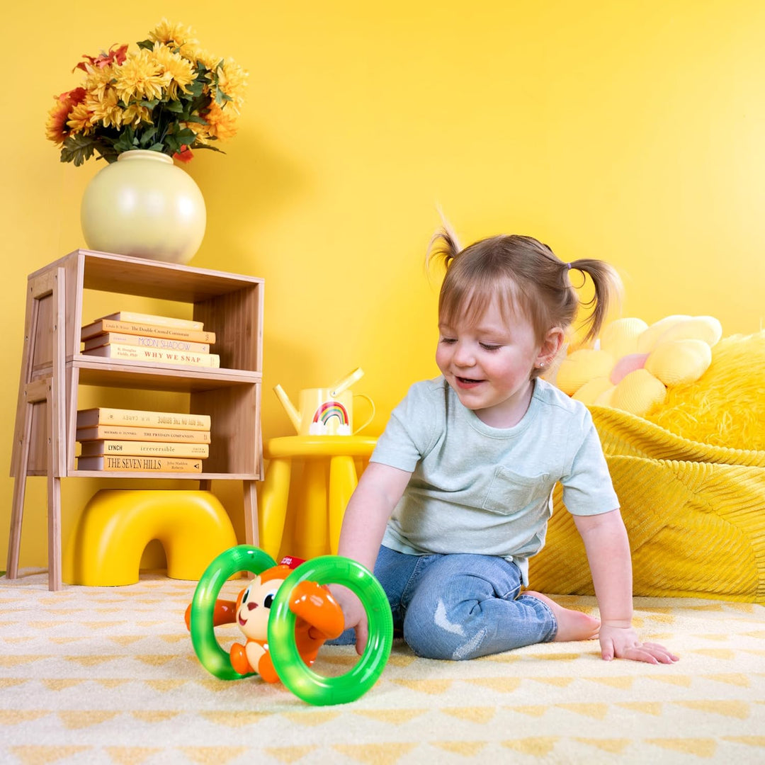 Bright Starts, Musikspielzeug AFFE mit leuchtenden, selbst Rollenden Rädern, Spielt Musik und Wirkt
