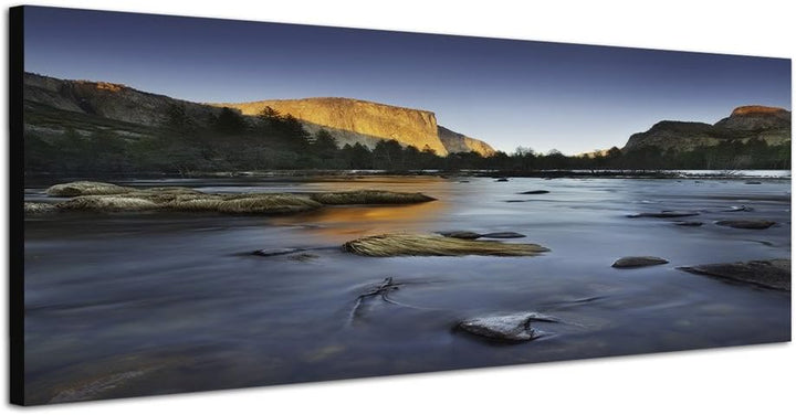 Paul Sinus Art Panoramabild auf Leinwand und Keilrahmen 150x50cm Felsen Bäume Fluss Steine Abendlich