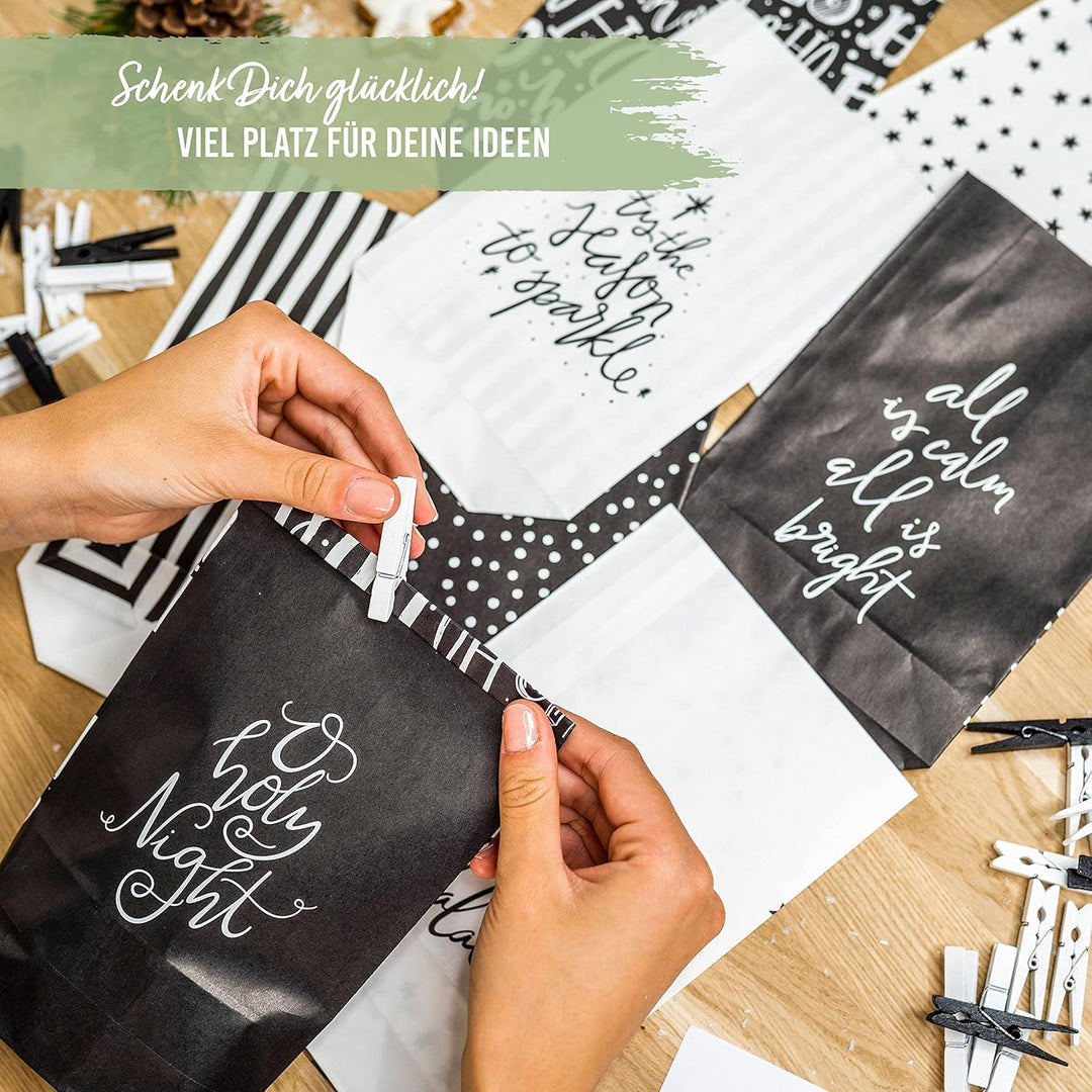 Papierdrachen Adventskalender zum Befüllen - 24 schwarze und weisse bedruckte Geschenktüten und 24 Z