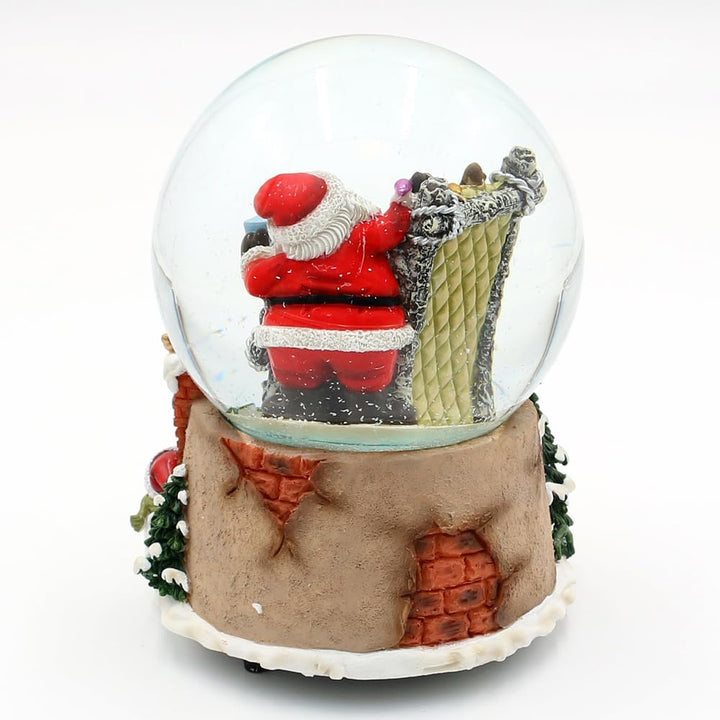 Schneekugel Rentier im Sessel und Weihnachtsmann, auf Kamin Sockel, mit Spielwerk, Melodie: Here Com