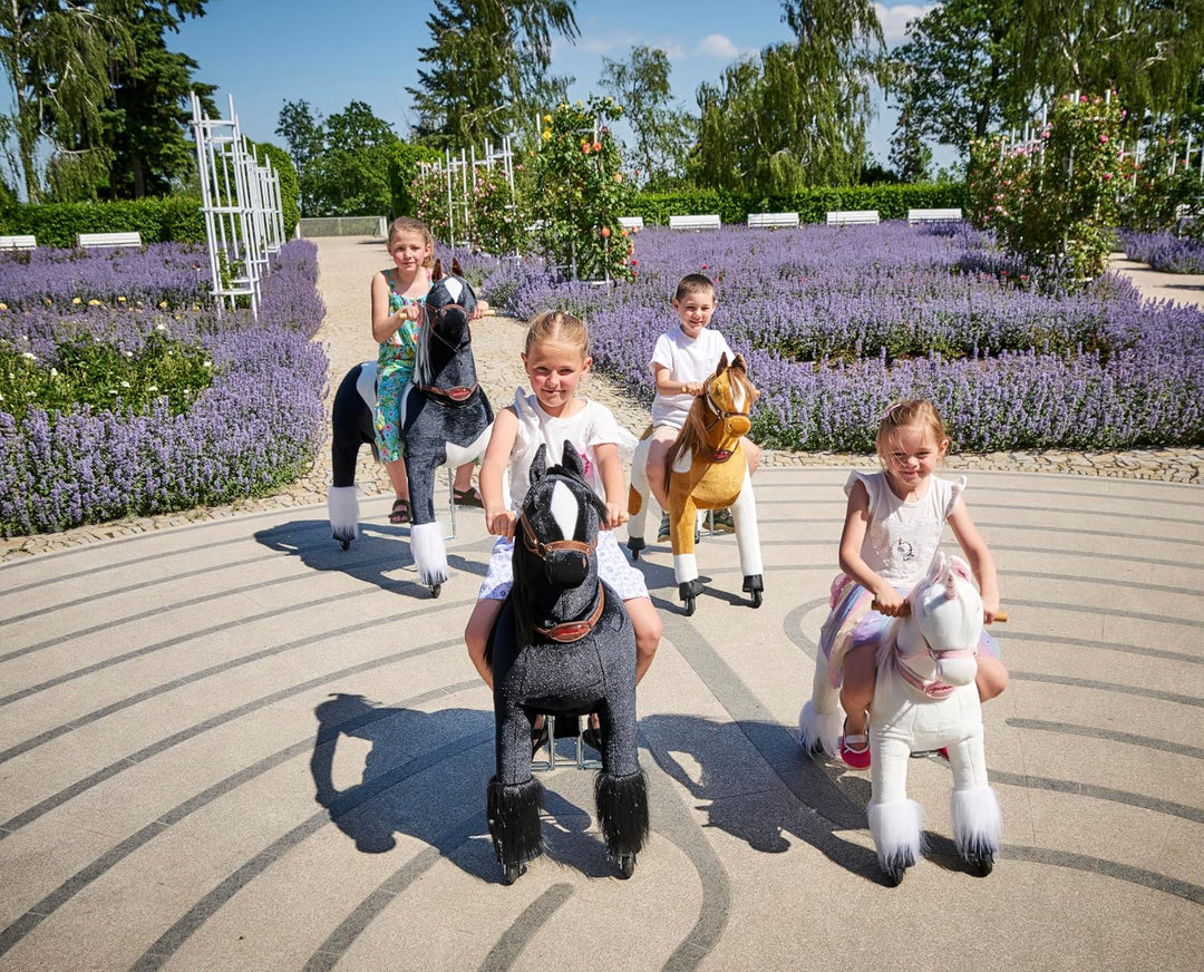 PONNIE Reitpferd mit Rollen Domino S (3-6 Jahre), Spielpferd zum Reiten mit Abnehmbarer Rosa Sattel