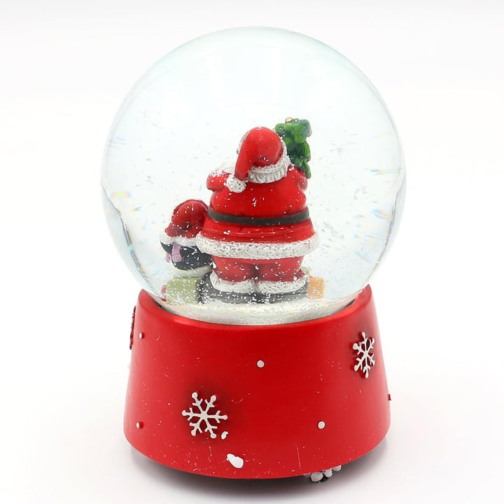 Schneekugel Santa mit Pinguin auf weihnachtlichen Sockel mit Spielwerk, Melodie Feliz Navidad, L/B/H