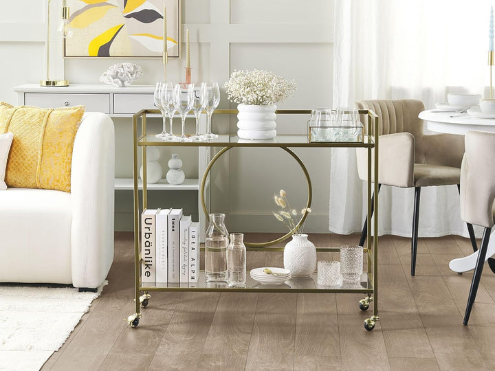 Beliani Servierwagen Glasplatte transparent/Gold mit Rollen glamourös Kerry