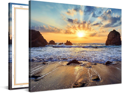 PICANOVA – Bild auf Leinwand Felsiger Strand Sonnenuntergang 100x75cm – Leinwandbild – Premium Leinw