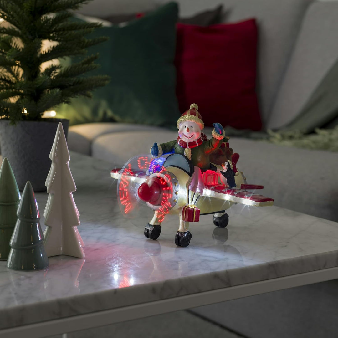 Konstsmide LED Szenerie Schneemann im Flugzeug, mit Animation, Geräuschsensor und 2 min Timer, 8 kal
