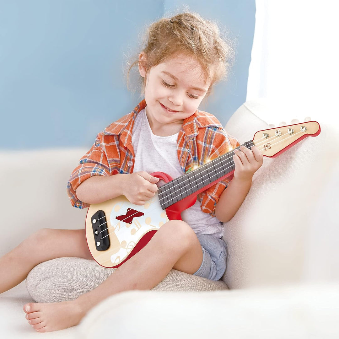 Hape Elektrische Ukulele mit stimmbaren Saiten und Führungslichtern für Kinder ab 3 Jahren, rot