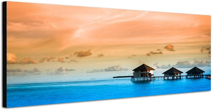 Paul Sinus Art Panoramabild auf Leinwand und Keilrahmen 150x50cm Meer Bungalows Wolkenhimmel Abendli