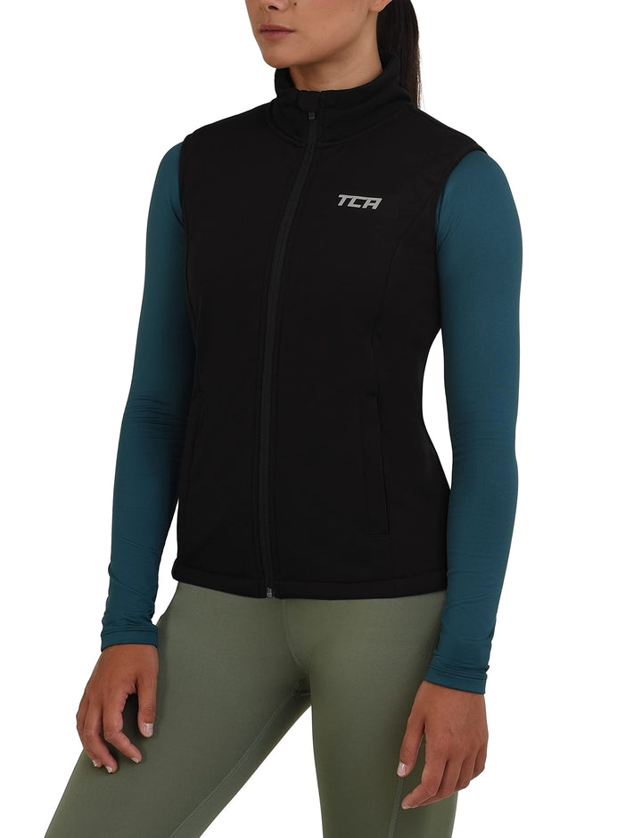 TCA Damen Flyweight winddichte Lauf- und Fahrradweste mit Reissverschlusstaschen, XS Schwarz