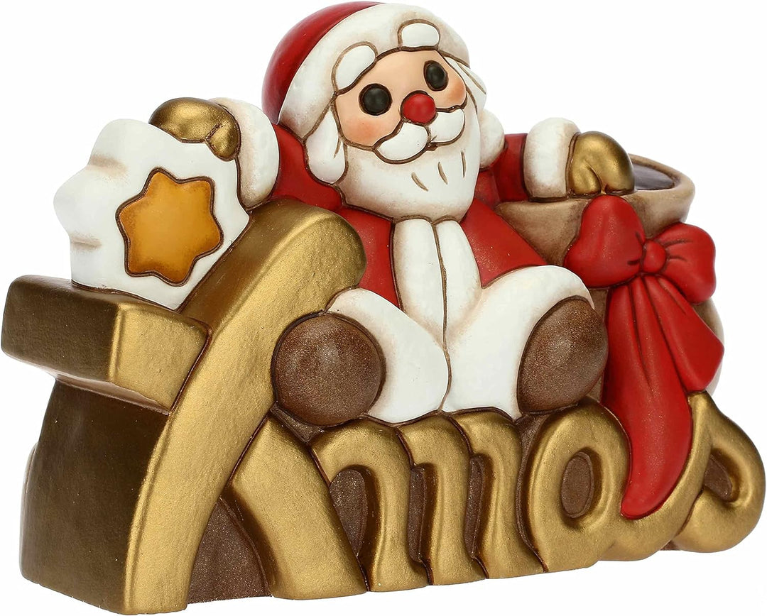 THUN - Weihnachten 2022 - Weihnachtsmann auf Xmas Schriftzug aus handverzierter Keramik - Weihnachts