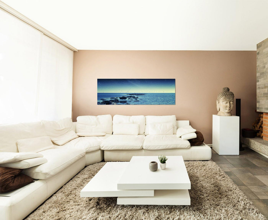 Paul Sinus Art Panoramabild auf Leinwand und Keilrahmen 150x50cm Meer Steine Vögel Morgengrauen Ster