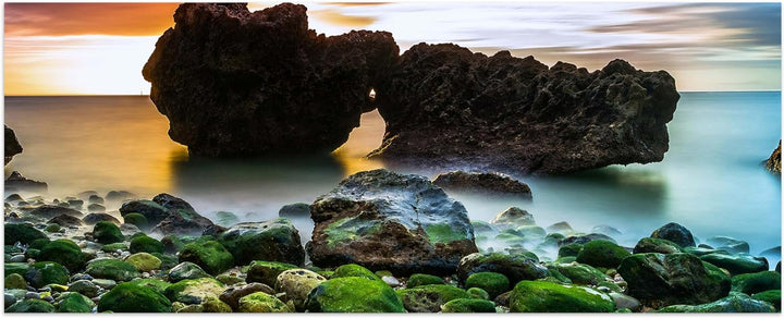 wandmotiv24 Leinwandbild Strand bei Sonnenuntergang mit Felsen 100x40cm (BxH) Bilder auf Leinwand, D