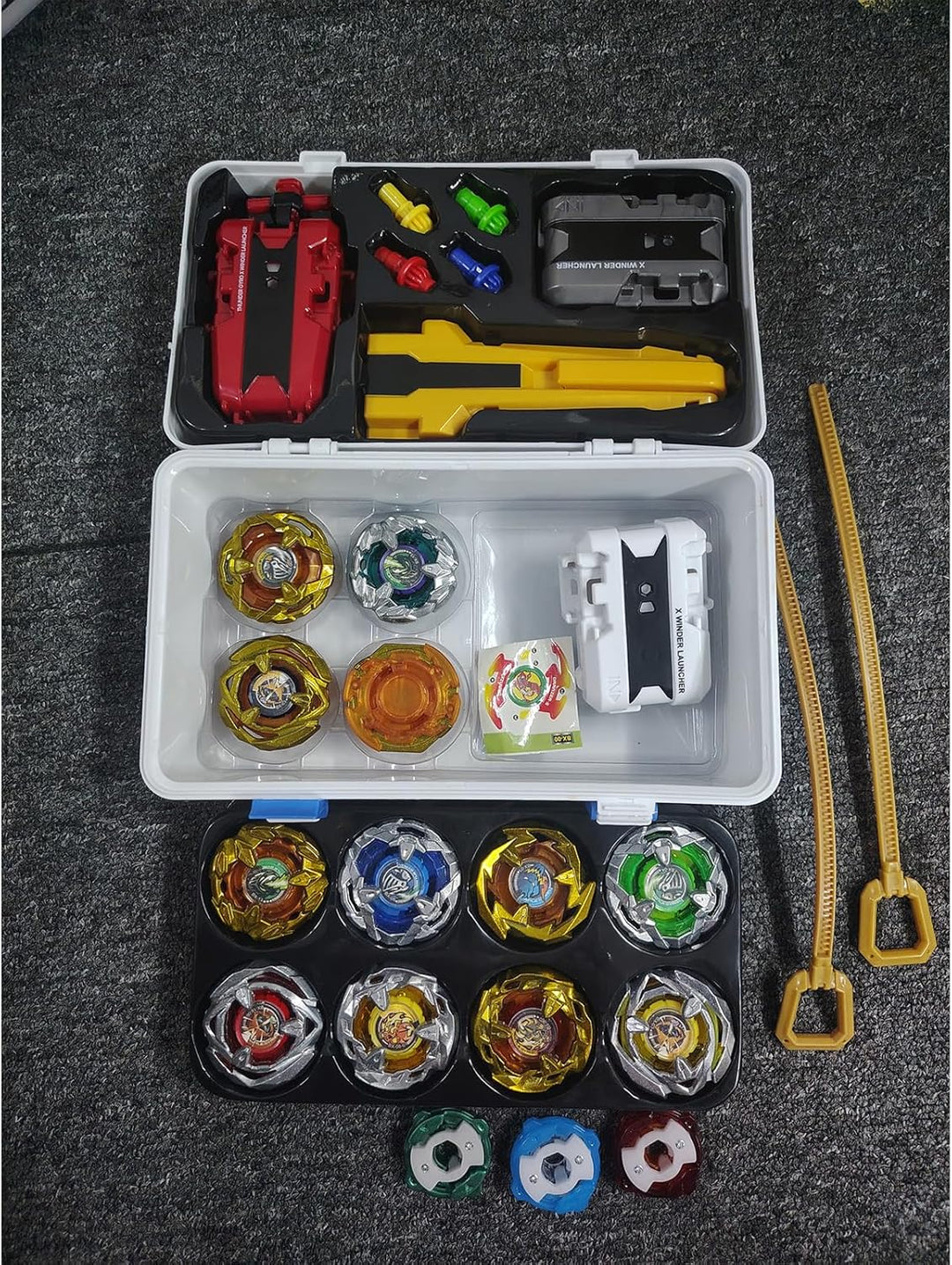 Battling Tops, 12 Kreisel, 3 Werfer, 1 Griff, 3 Mittelringe und 4 Basen, mit Aufbewahrungsbox, Gebur