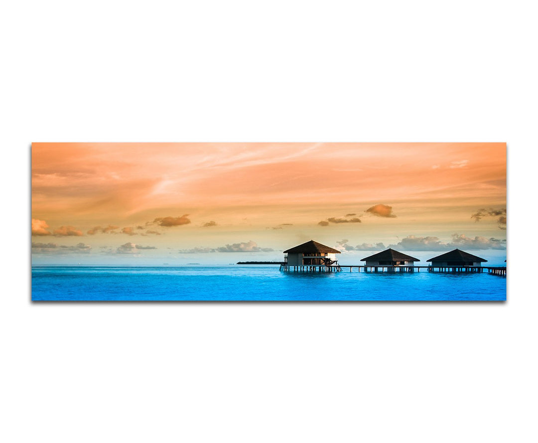 Paul Sinus Art Panoramabild auf Leinwand und Keilrahmen 150x50cm Meer Bungalows Wolkenhimmel Abendli
