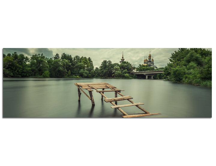 Paul Sinus Art Panoramabild auf Leinwand und Keilrahmen 150x50cm See Holzsteg Bäume Kirche Himmel