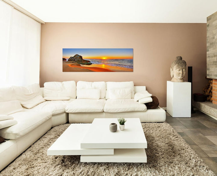 Paul Sinus Art Panoramabild auf Leinwand und Keilrahmen 150x50cm Strand Meer Sonnenaufgang Fels