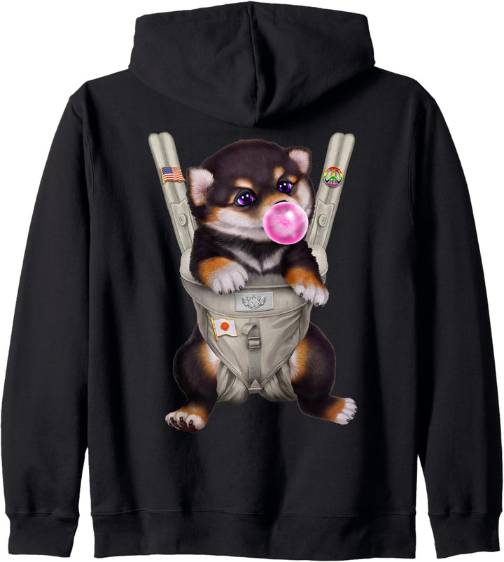 Schwarzer Shiba Hund mit Kaugummi in der Babytrage Kapuzenjacke