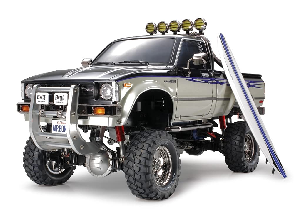 TAMIYA TMYTAM58397 1:10 RC Toyota HiLux HighLift 4x4 3-Gang - ferngesteuertes Auto - inkl. Surfbrett
