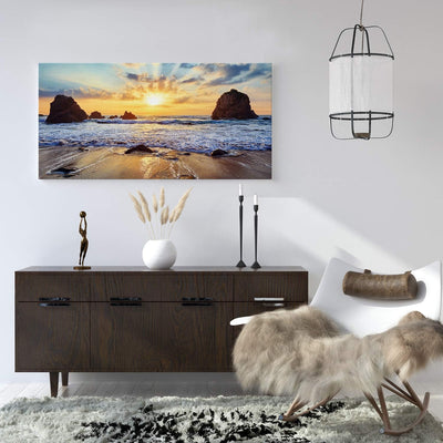 PICANOVA – Bild auf Leinwand Felsiger Strand Sonnenuntergang 100x50cm – Leinwandbild – Premium Leinw