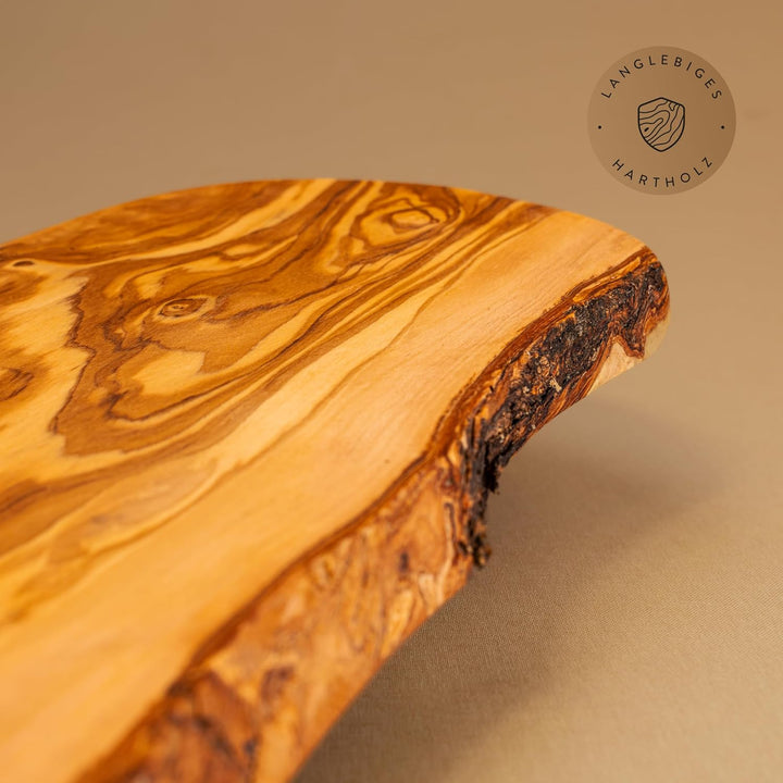 das Olivenholzbrett® Schneidebrett Olivenholz, Brotzeitbrett aus Holz mit naturbelassenem Rand, 25 c