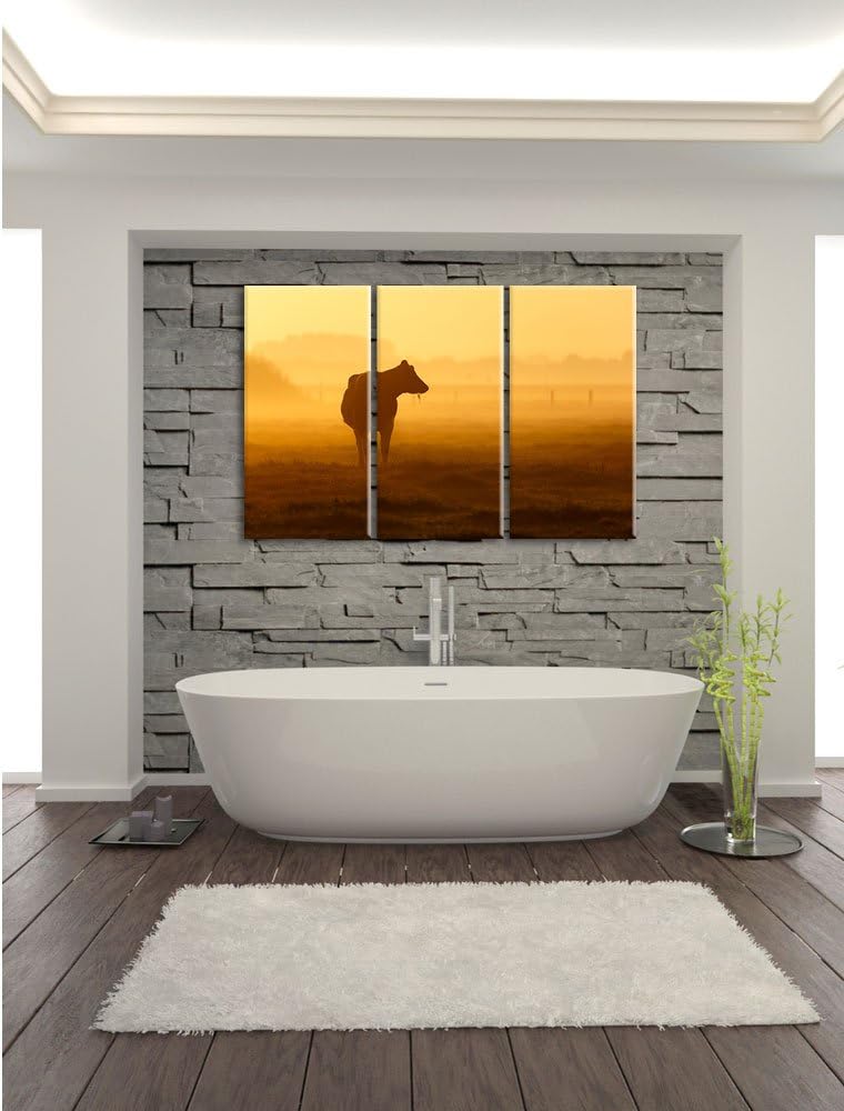 Pixxprint eine fressende Kuh auf der Weide als Leinwandbild - Grösse: 3-Teilig (120x80cm) - Wandbild